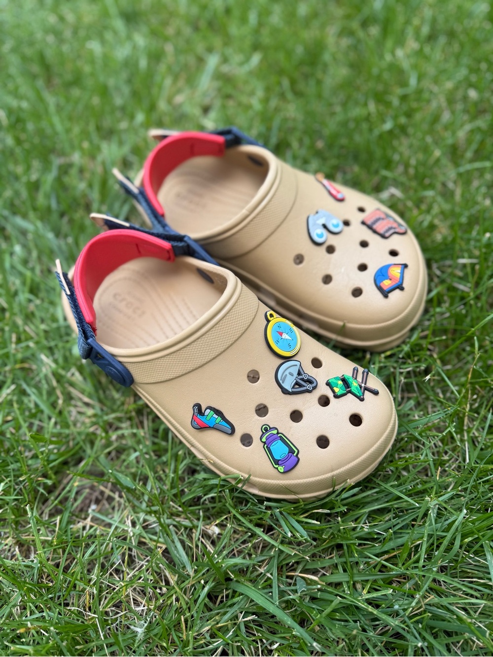 CROCS Tan Slip-On Clogs with Navy & Red Heel Straps and Colorful Charms